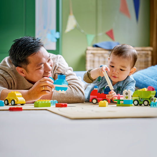 parents and child playing with lego duplo creative vehicles