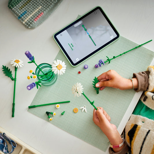 girl building lego daisies