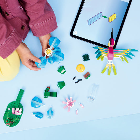 girl building hummingbird lego set