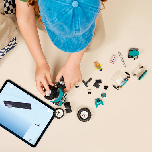 boy building lego tractor