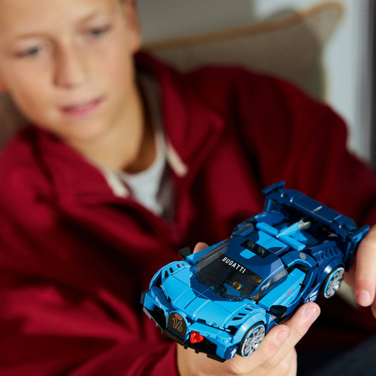 boy holding speed champions lego blue car