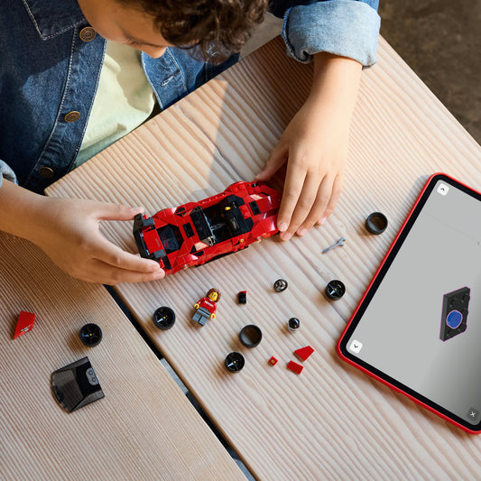 boy building lego ferrari sf90 xx stradale sports car
