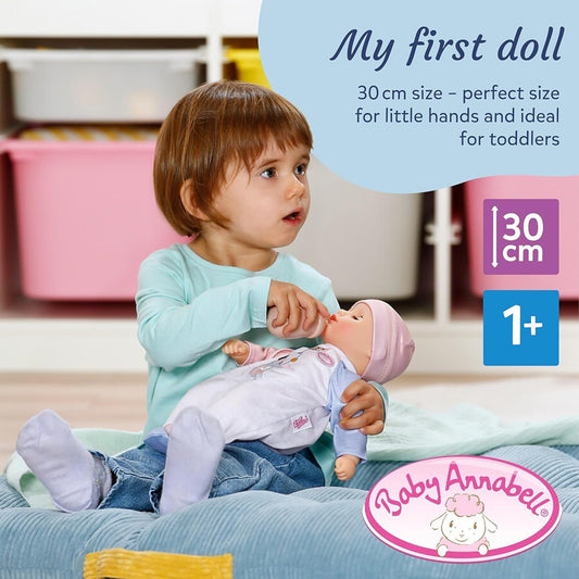 toddler playing with baby annabell doll