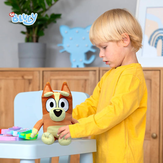 boy playing with bingo plush