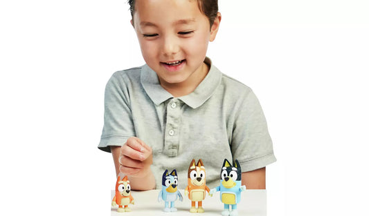 young boy playing with four dog mini figures