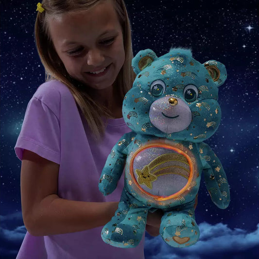 girl playing with blue and gold care bear with light up belly