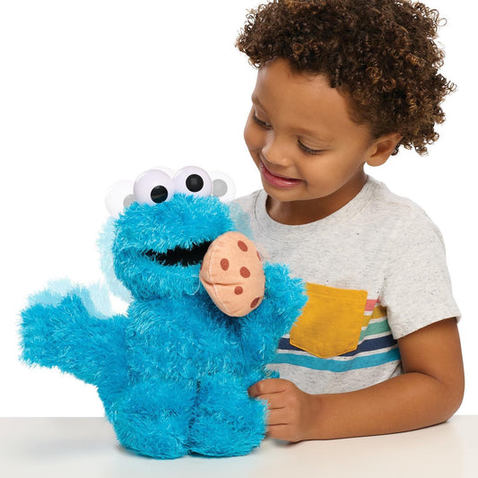 boy holding cookie monster plush