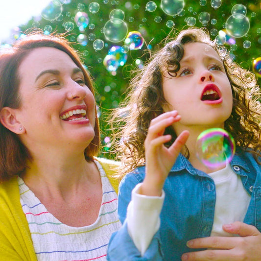 child playing with bubbles