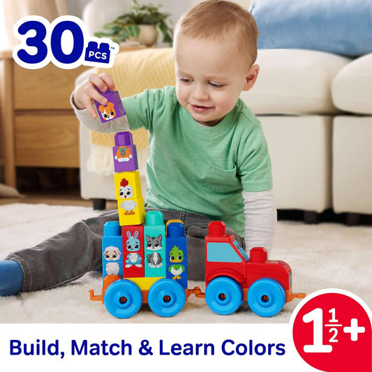 baby playing with building set tractor and blocks
