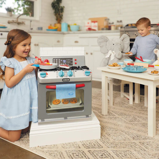 girl and boy playing with toy oven