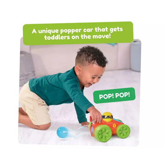 young boy playing with pop and go racer car