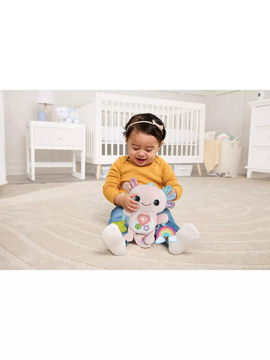 baby playing with colourful plush toy