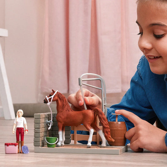 girl playing with horse wash playset