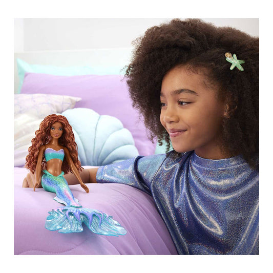 girl playing with ariel doll