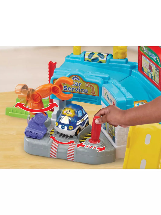 small hand reaching to play with colourful play driver repair set