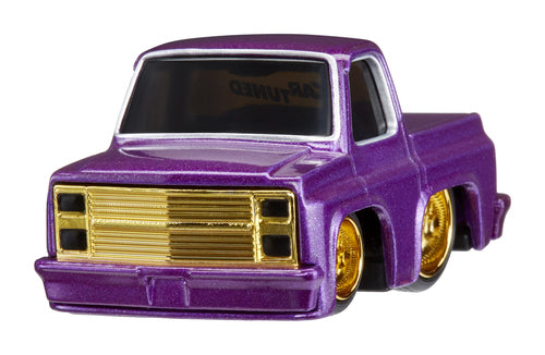 87 Chevy C10 small car with bold purple paint and gold alloys