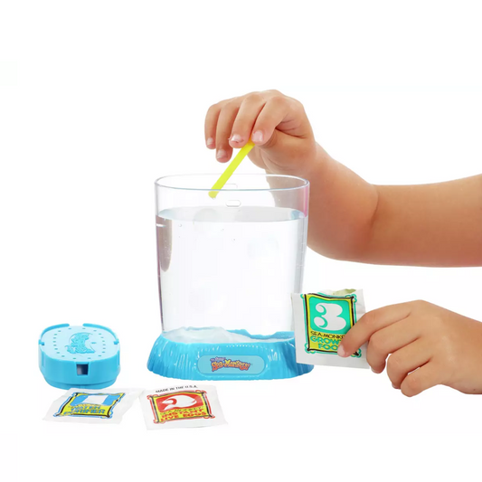 child mixing the sea monkeys into water