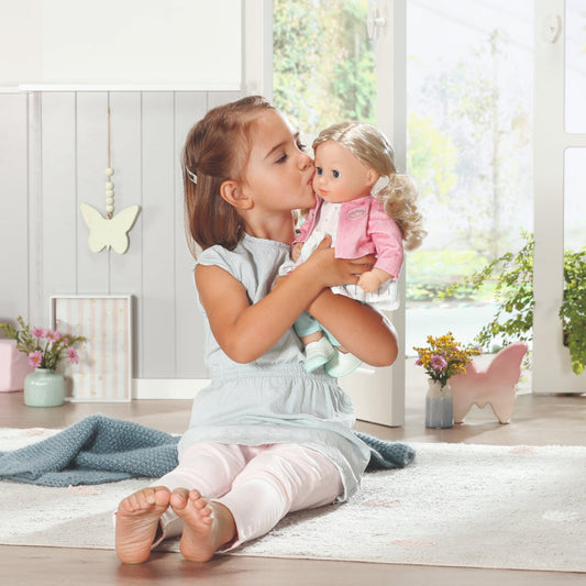 Child playing with the baby annabelle little sofia doll