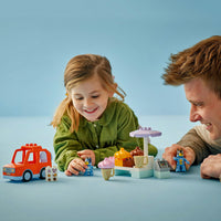 Girl and father playing with bluey lego icecream toys on blue background 