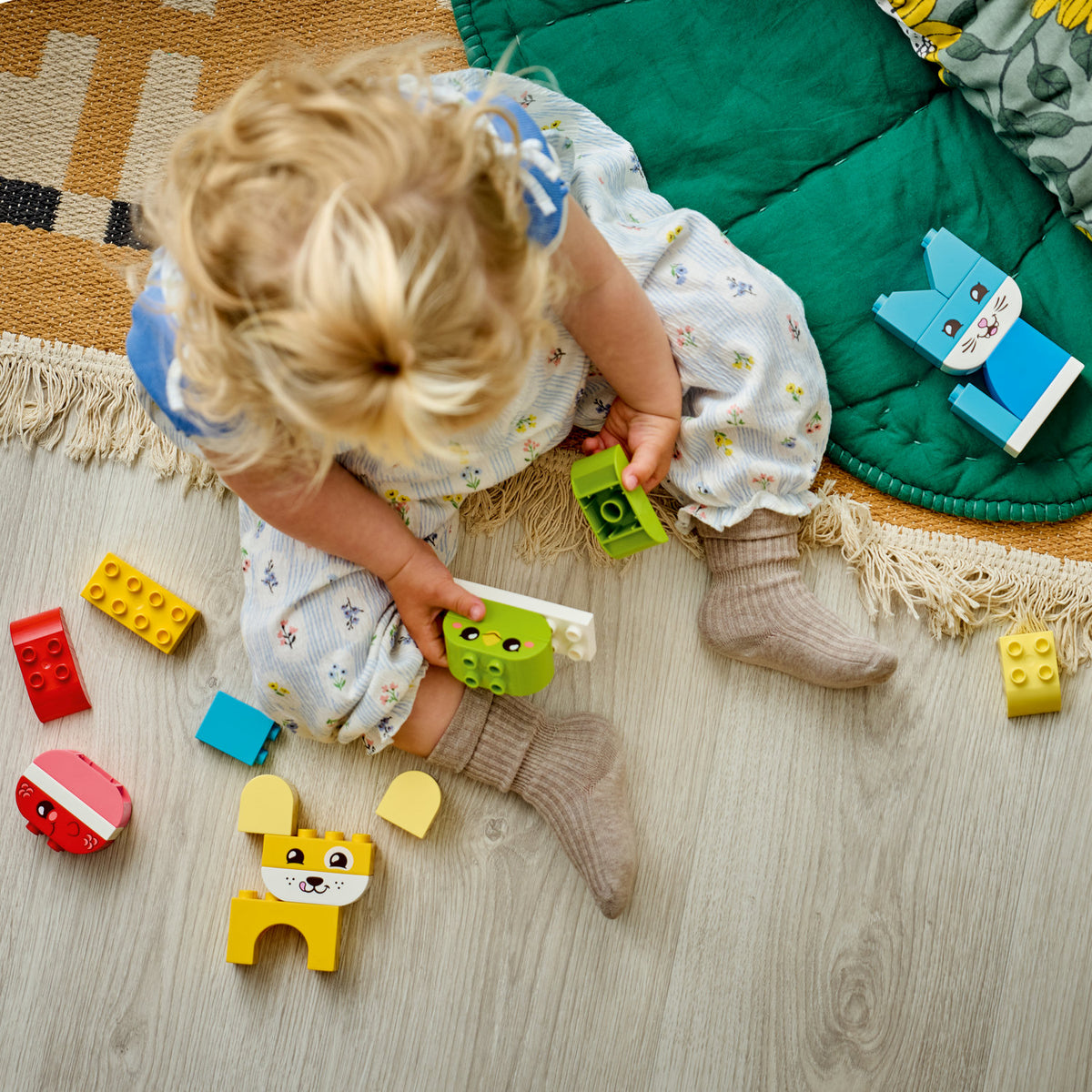 child playing with lego animals 