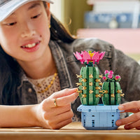 girl playing with flowering cactus lego 