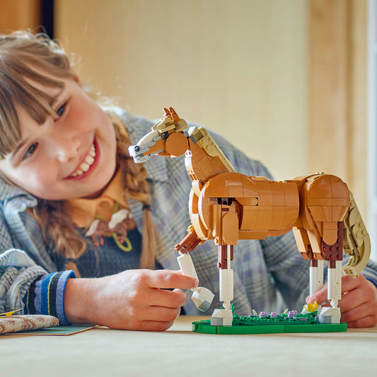 young girl playing with LEGO horse 