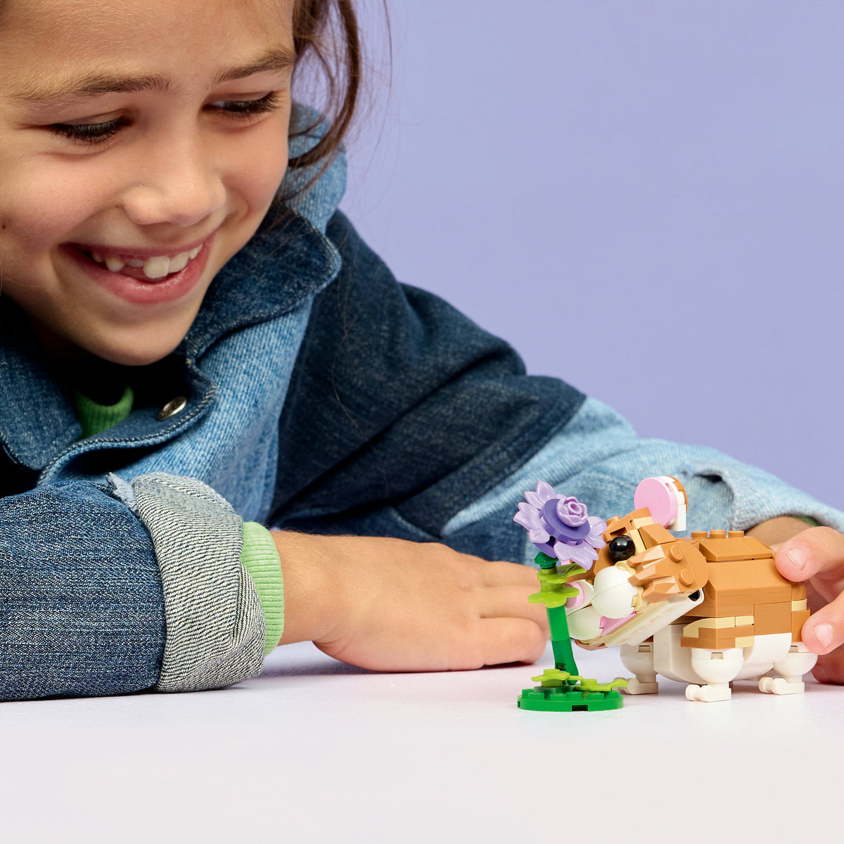 girl playing with lego hamster set
