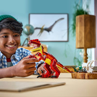 boy playing with 3 in 1 dinosaur lego set 