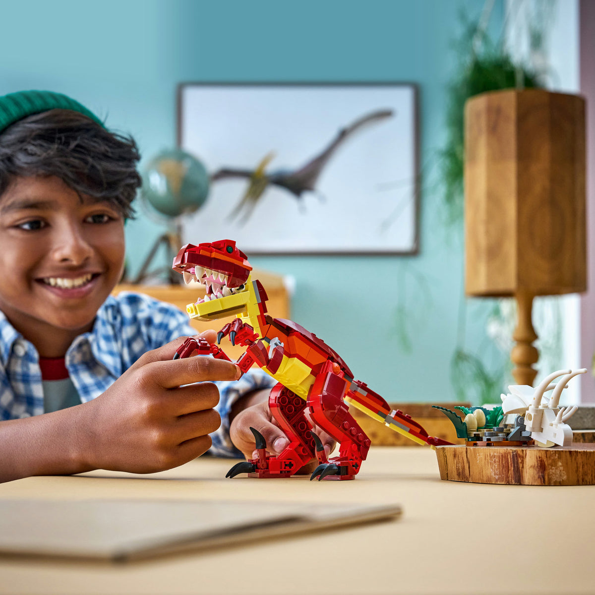 boy playing with 3 in 1 dinosaur lego set 