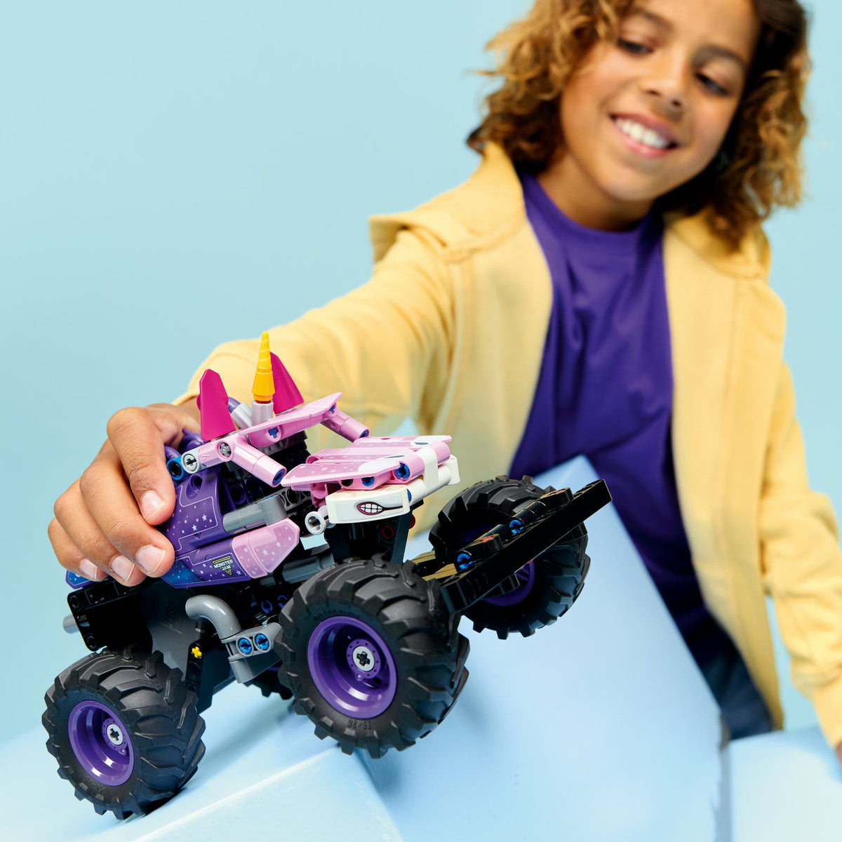 child playing with monster jam sparkle smash pullback