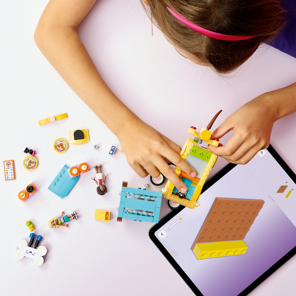 girl building pet accessories van lego set 