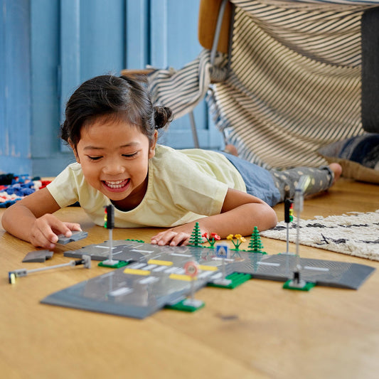 girl playing with lego plates 