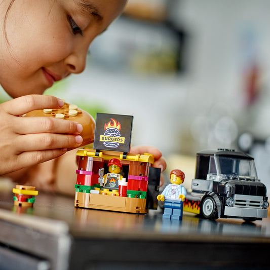 girl playing with lego burger van 