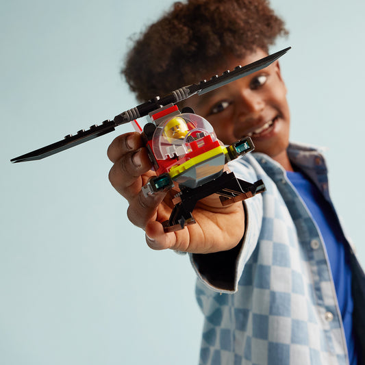 boy holding LEGO Helicopter 