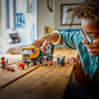 boy playing with lego city cement mixer 