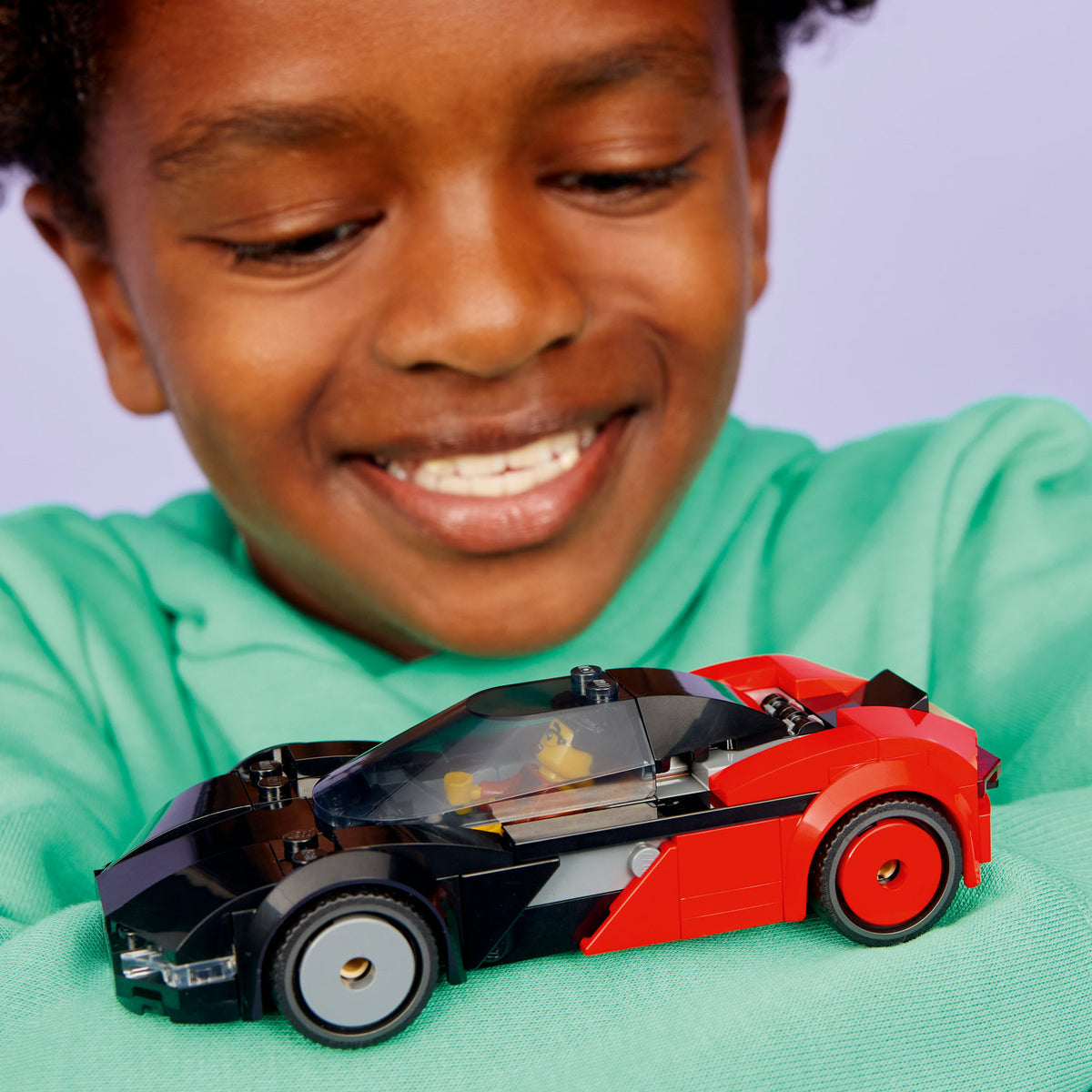 boy playing with lego city ev supercar  