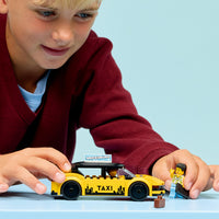 boy playing with lego city yellow taxi 