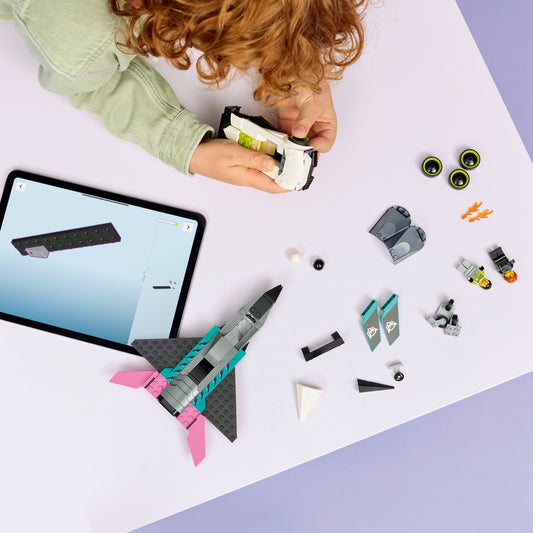 boy building lego city jet vs car