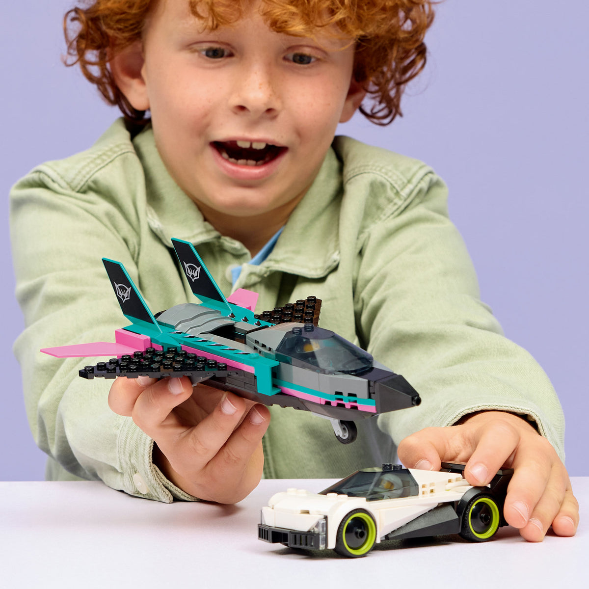 boy playing with lego city jet vs car