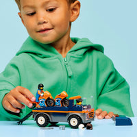 boy playing with motorcycle transport set 