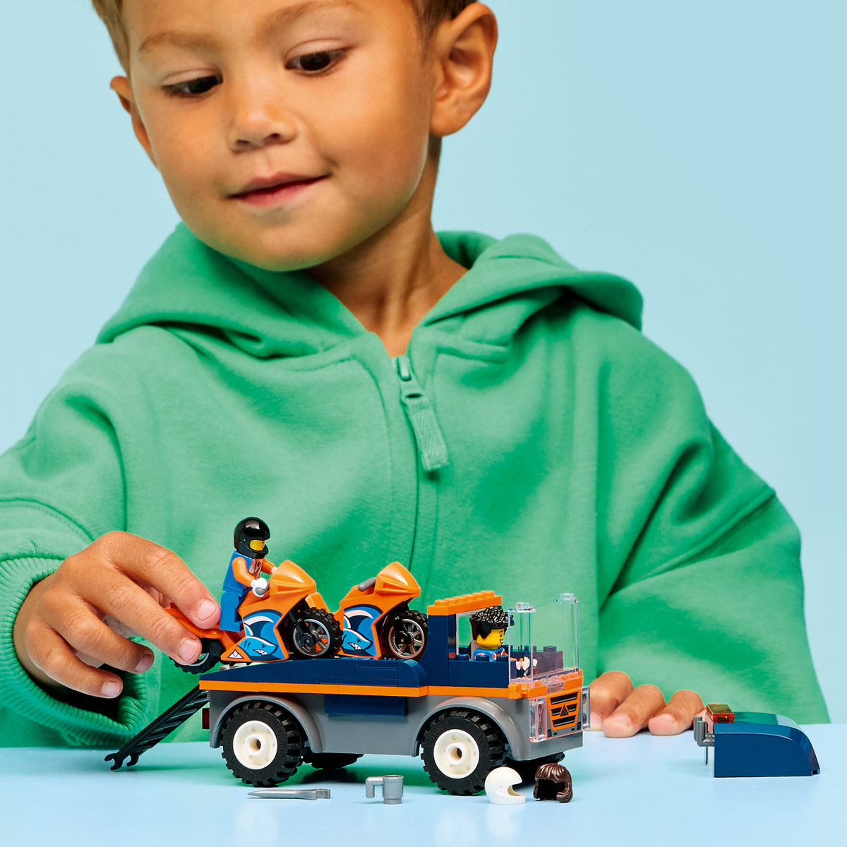 boy playing with motorcycle transport set 