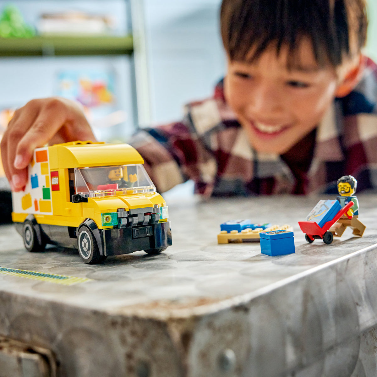 boy playing with lego van 