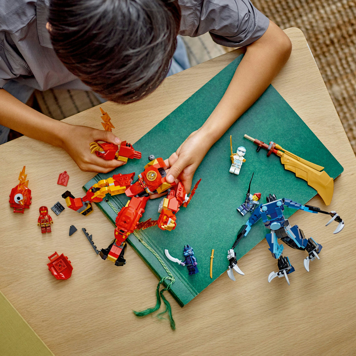 boy playing with lego ninjago set with four mini figures 