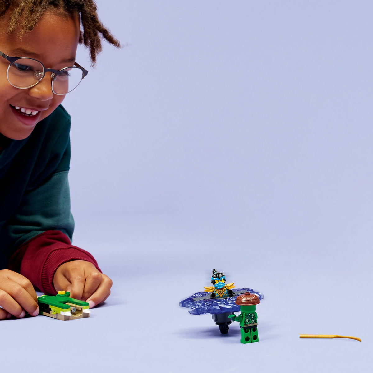 boy playing with lego nya vs mutation monster spinner 