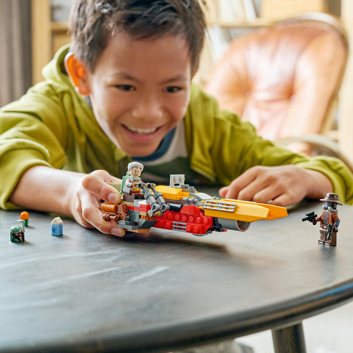 boy playing with lego star wars cobb vanths speeder