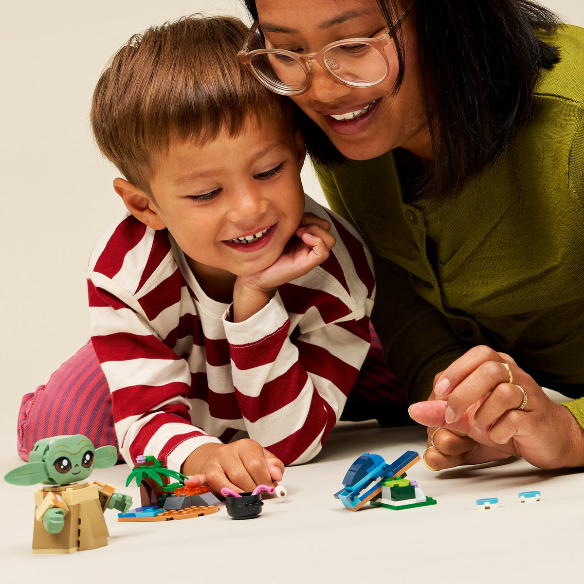 boy playing with grogus homestead lego set 