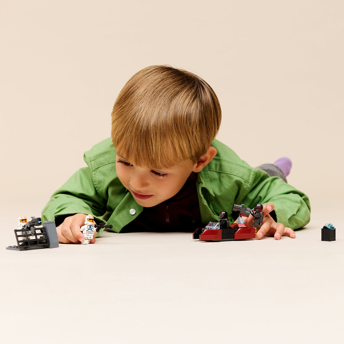 boy playing wth lego star wars siege of madalore battle pack 