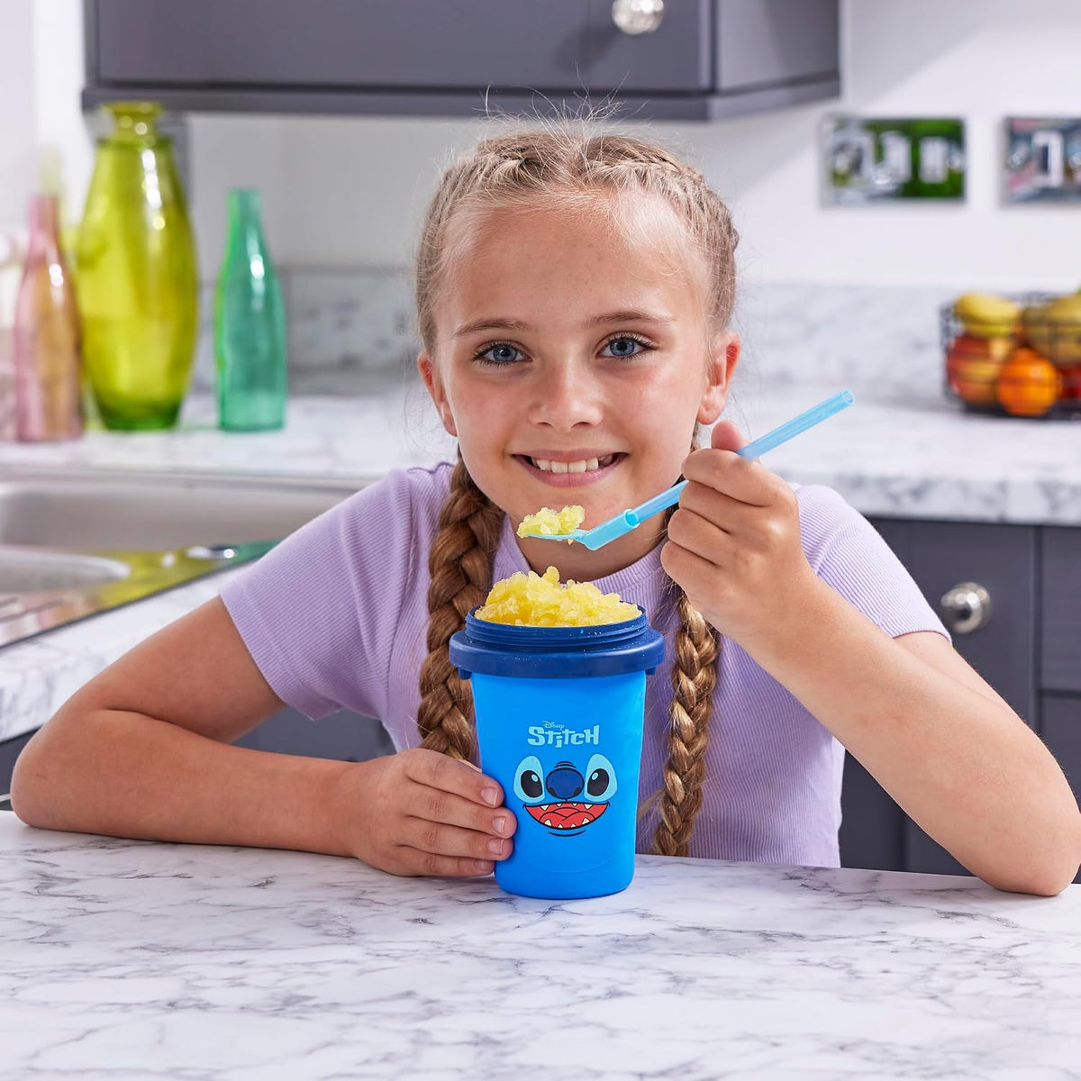 ChillFactor Disney Stitch Slushy Maker Blue – child eating a slushy