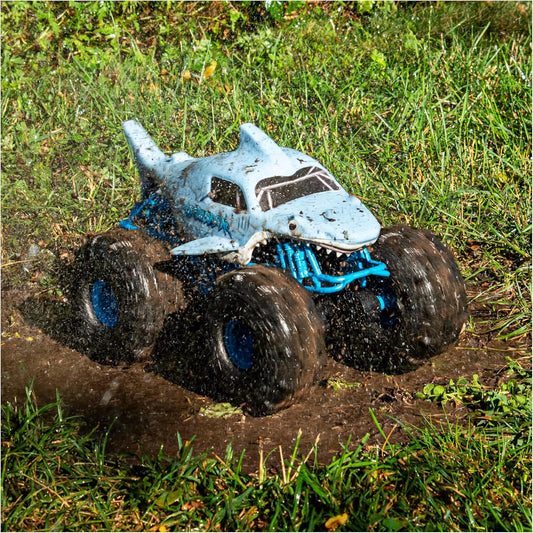 Toy monster truck with shark body on grass