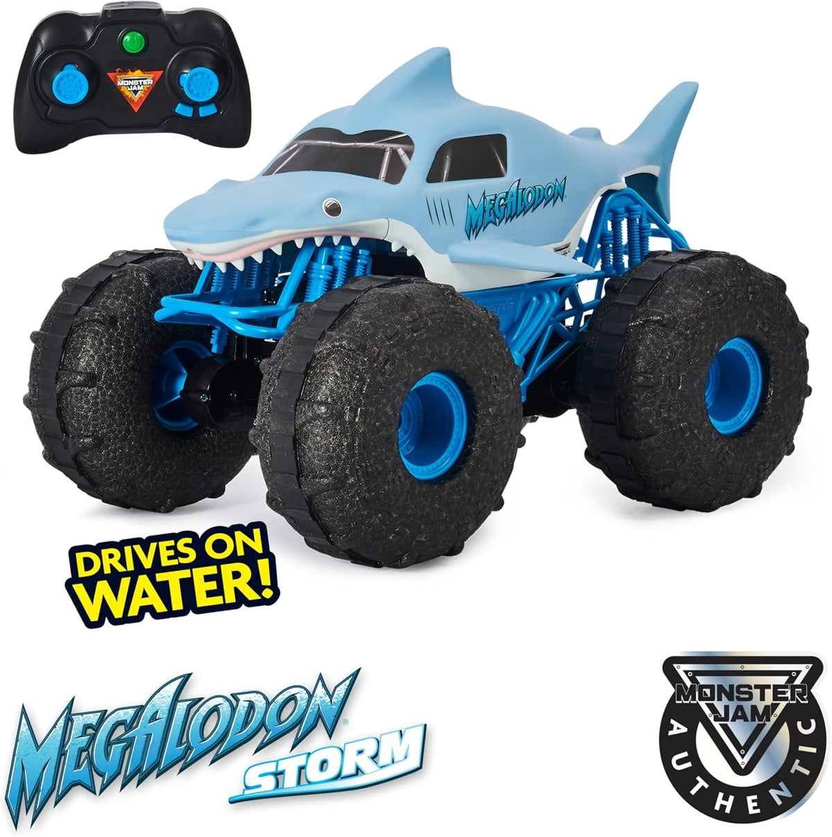 Toy vehicle resembling a megalodon with monster truck wheels and remote control, featuring Monster Jam branding.